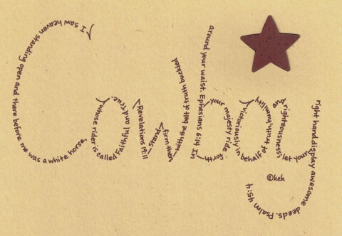 Cowboy written in hand-printed Bible verses in burgundy ink on brown paper with rustic metal star embellishment