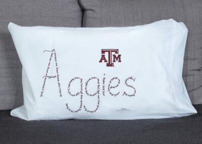 Aggies written in hand-printed Bible verses in maroon ink on white pillowcase
