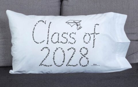 Class of 2028 written in hand-printed Bible verses in black ink on white pillowcase