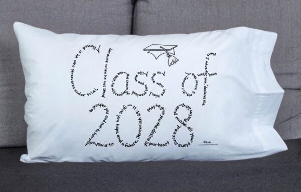 Class of 2028 written in hand-printed Bible verses in black ink on white pillowcase